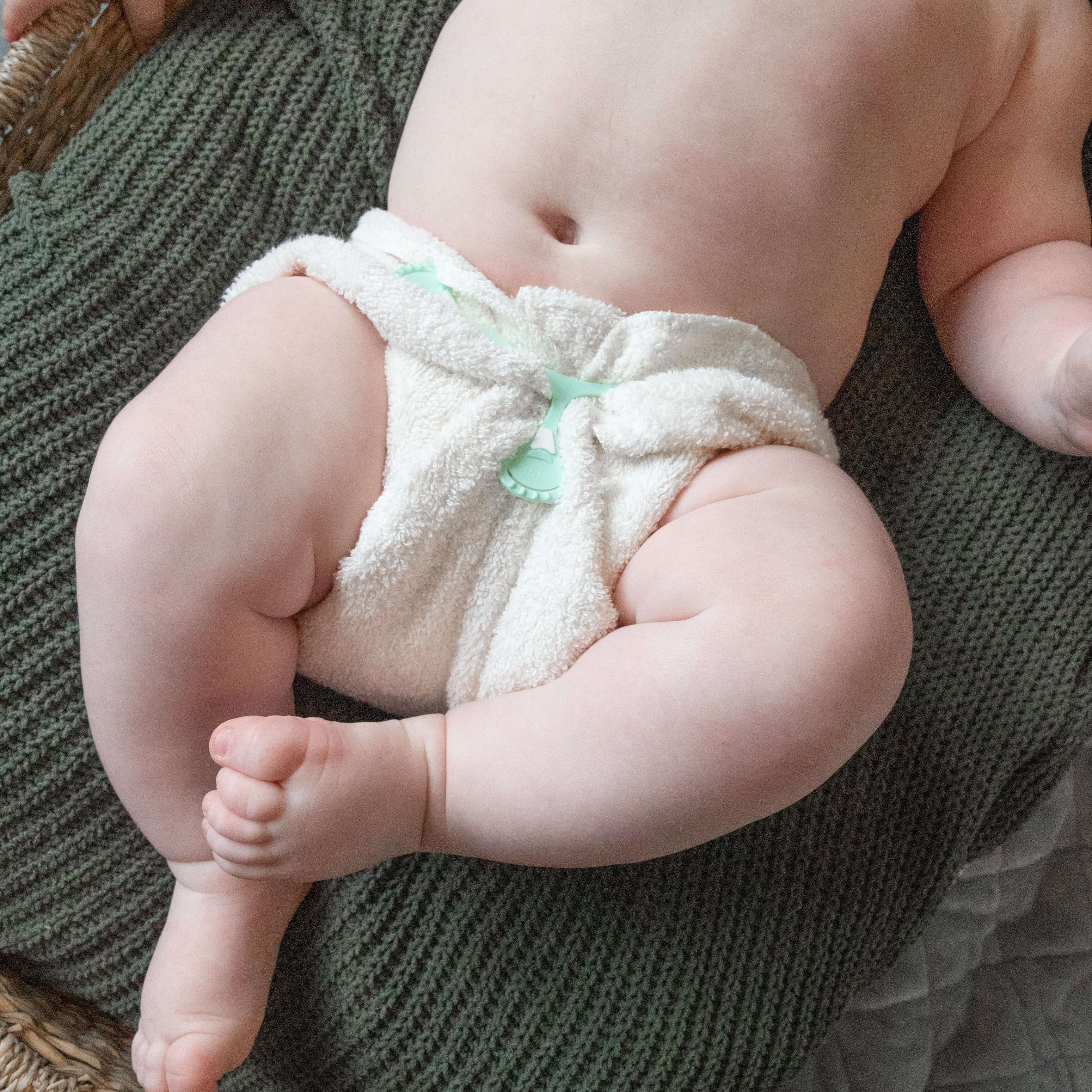 A newborn baby wearing a Bayrli bamboo cotton terry cloth diaper